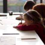 Children drawing around a table