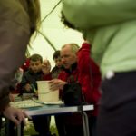 People chatting in a tent