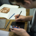 A person doing some etching