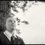 Child next to a tree - Black and white photo