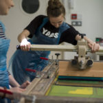 A person creating a screenprint