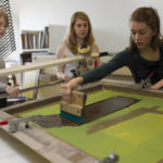 A group of people screenprinting