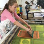 A child creating a print